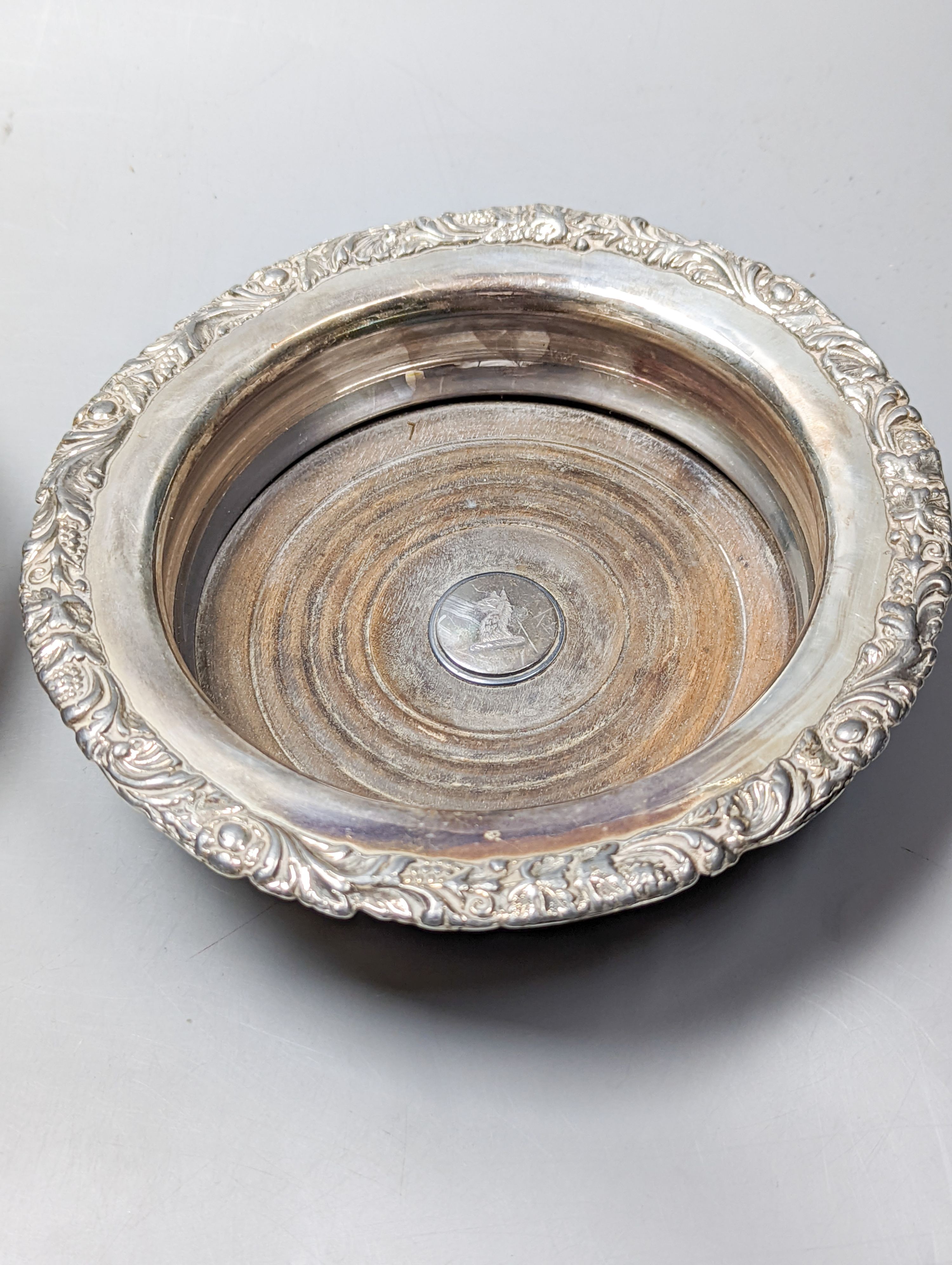 A George II silver toddy ladle, with spiral twist baleen handle, London, 1740 (a.f.) and a pair of later silver plated wine coasters, diameter 16.8cm.